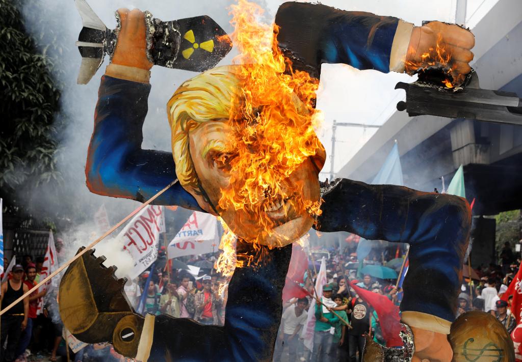 Protesters burn an effigy of U.S. President Trump, who is attending the ASEAN Summit and related meetings in Manila